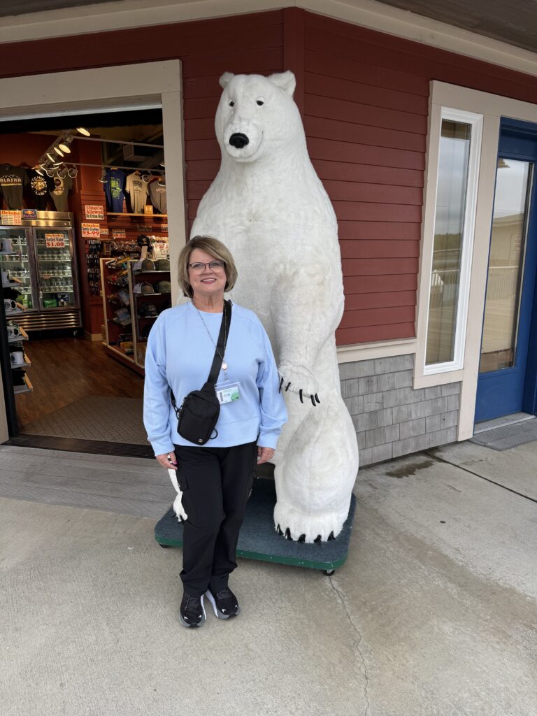 Sherry standing outside of a store in Ketchikan, Alaska with a bear.