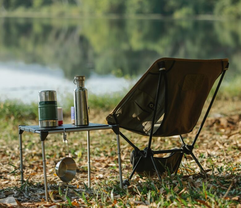 camp chair with table near water for ultimate packing tips